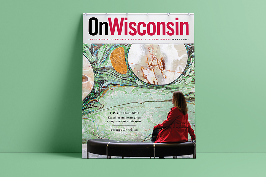 On Wisconsin magazine cover featuring a woman in a red coat sitting in front of a wall covered in abstract mosaic art.