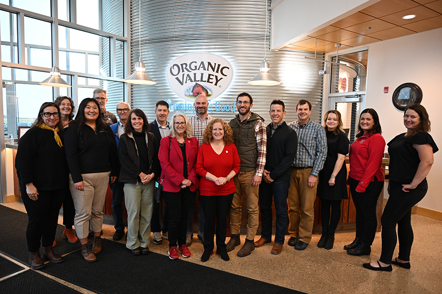 Chancellor Jennifer Mnookin stands in the center of a group photo at the Organic Valley headquarters in La Farge, Wisconsin