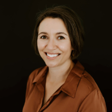 Headshot of Cassandra Willyard. She has dark hair and is wearing a terra cotta collared shirt.