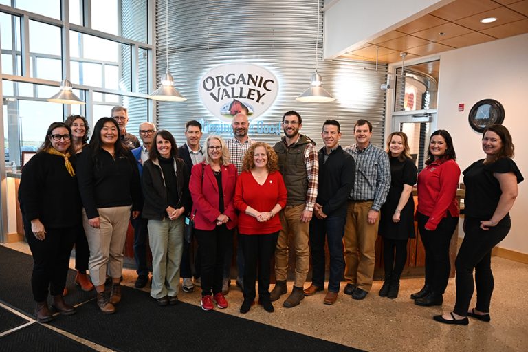 Chancellor Jennifer Mnookin stands in the center of a group photo at the Organic Valley headquarters in La Farge, Wisconsin